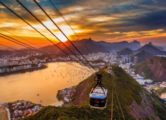 A cable car is floating above Rio De Janeiro at sunset with city and mountains in the background, HD Desktop Wallpaper
