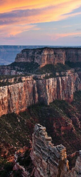 The Grand Canyon cliffs display rich colors during sunset with a vibrant sky, 2K Phone Wallpaper