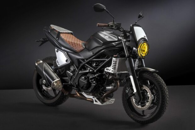 A black Suzuki Sv650 motorcycle features a brown leather seat and yellow headlight, HD Desktop Wallpaper
