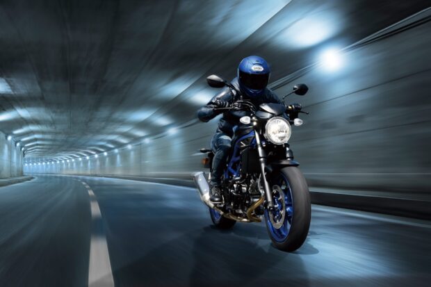 A rider is speeding on a Suzuki Sv650 in a well lit tunnel creating motion blur, HD Desktop Wallpaper