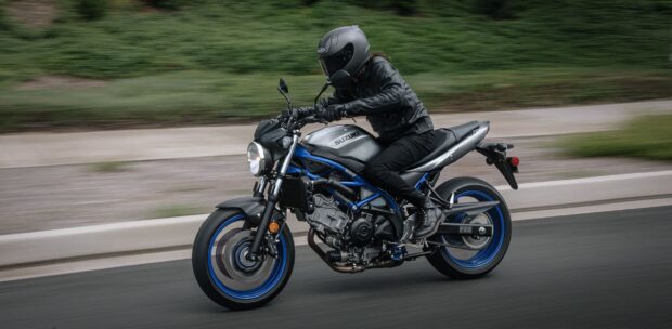 A person wearing black gear rides a Suzuki Sv650 motorcycle on a highway, HD Desktop Wallpaper