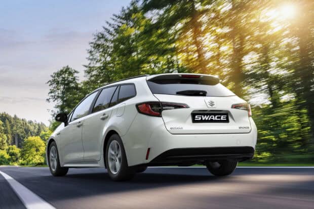 A white Suzuki Swace drives along a sunny road surrounded by green trees, HD Desktop Wallpaper