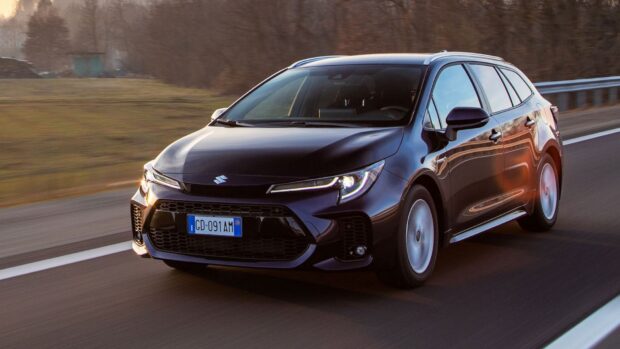 A black Suzuki Swace is driving smoothly on a highway surrounded by trees, HD Desktop Wallpaper