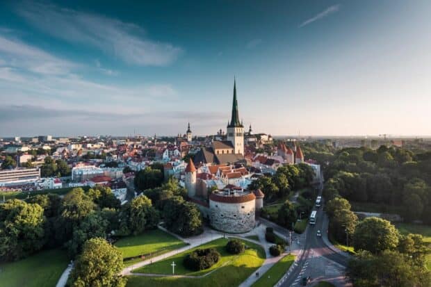 A serene view of Tallinn city with the church spire and greenery showcasing Estonia Wallpapers, HD Desktop Wallpaper