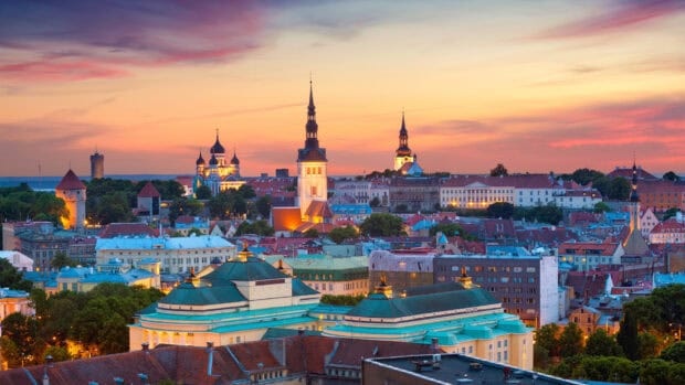 The Tallinn cityscape shows tall spires against the sunset sky in Estonia Wallpapers, HD Desktop Wallpaper