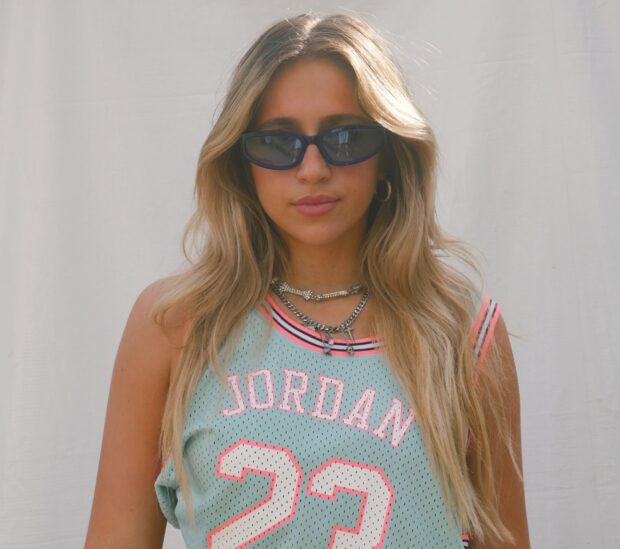 A woman wearing sunglasses and a Jordan jersey with blonde hair, HD Mobile Wallpaper