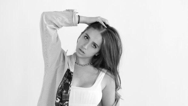 Tate Mcrae posing with hand in hair wearing a striped shirt and necklace, HD Desktop Wallpaper
