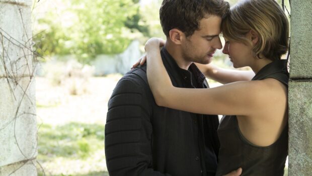 A tender moment between two Allegiant characters sharing a close embrace in a bright outdoor setting, 4K Desktop Wallpaper