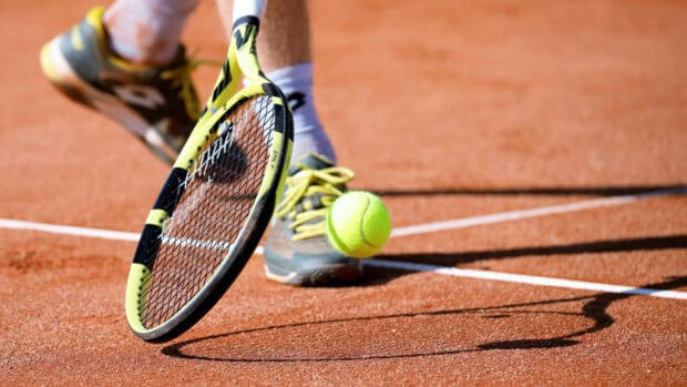 A tennis player hits the ball on a clay court during a match, HD Desktop Wallpaper