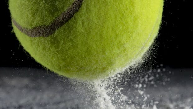 A close up shot of a tennis ball striking the surface and creating a powder burst, HD Desktop Wallpaper