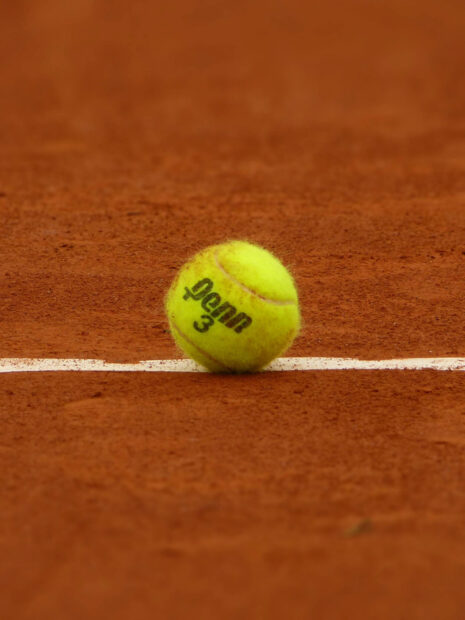A tennis ball rests on the white line of a clay tennis court, HD Mobile Wallpaper
