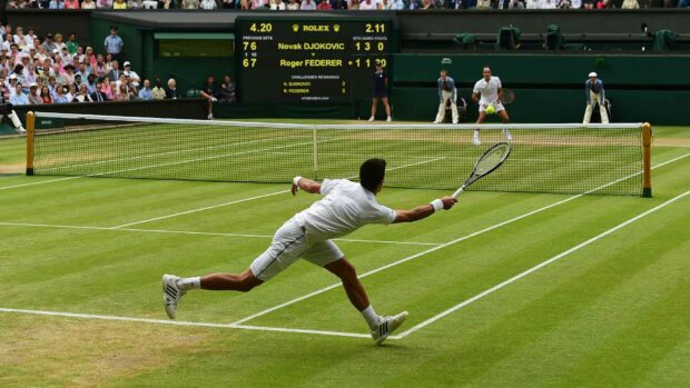 Tennis match action with players in white stretching to hit the ball on the grass court, HD Desktop Wallpaper