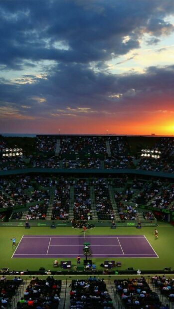 A tennis match is taking place on a purple court with a sunset sky in the background, HD Mobile Wallpaper
