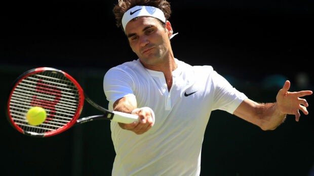 A tennis player is focused on hitting a forehand shot with a red racket during a match, 4K Desktop Wallpaper