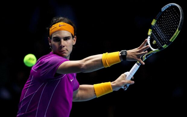 A tennis player is focused on hitting a forehand during a match, HD Desktop Wallpaper