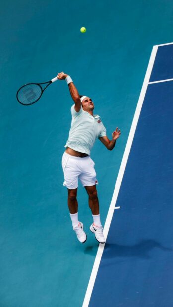 A tennis player is jumping to hit a serve on the blue court with a yellow ball, HD Mobile Wallpaper