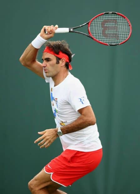 A tennis player focuses intensely before executing a backhand shot during a match, HD Desktop Wallpaper