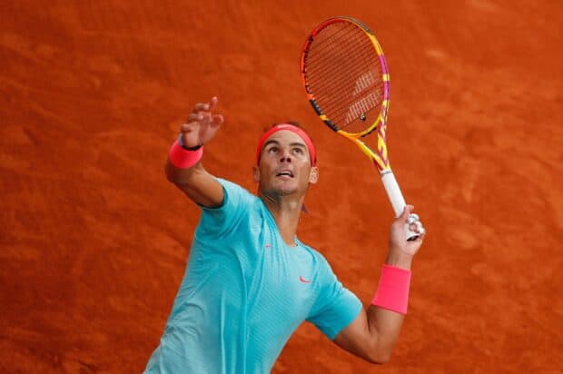 A tennis player in blue shirt prepares to serve during French Open Roland Garros on clay court, 2K Desktop Wallpaper