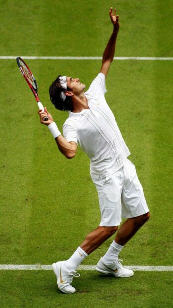 A tennis player serving the ball during a match on a grass tennis court, HD Mobile Wallpaper