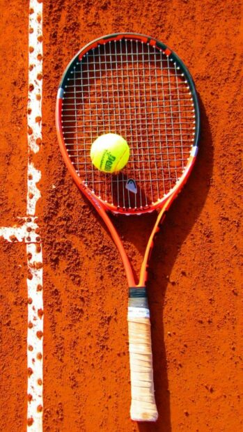 A tennis racket and ball resting on the clay surface beside the white court line, HD Phone Wallpaper