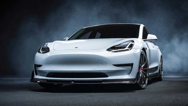 A white Tesla Model 3 is showcased in a dark smoky environment emphasizing its sporty design, HD Desktop Wallpaper