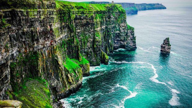 The Aran Islands feature dramatic cliffs covered in green vegetation alongside the vibrant turquoise sea, 4K Desktop Wallpaper