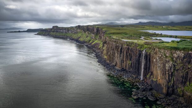 The Aran Islands feature rugged cliffs and serene waters under a cloudy sky, 4K Desktop Wallpaper