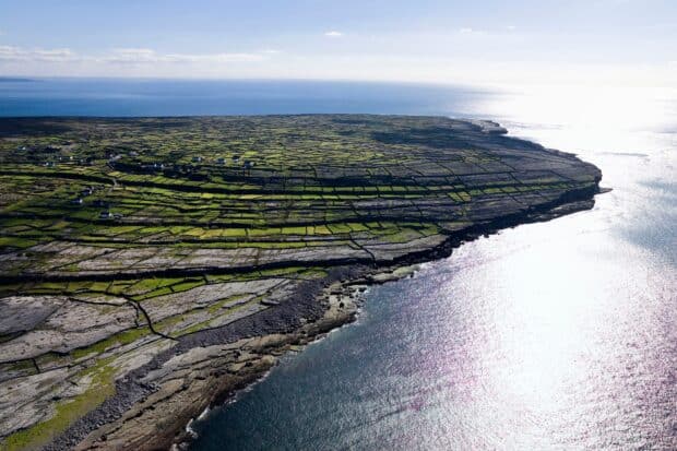 A breathtaking view of the Aran Islands landscape featuring stone walls and coastal cliffs, HD Desktop Wallpaper