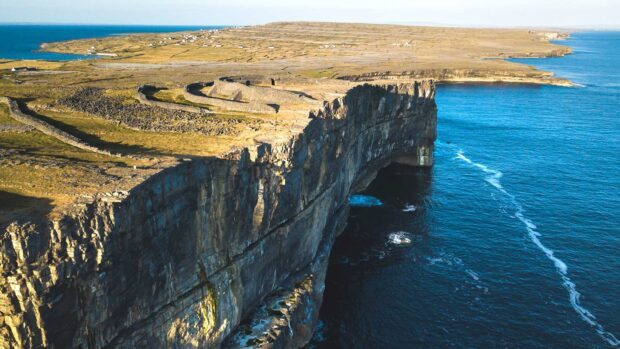 The Aran Islands feature dramatic cliffs meeting the deep blue ocean under clear skies, HD Desktop Wallpaper
