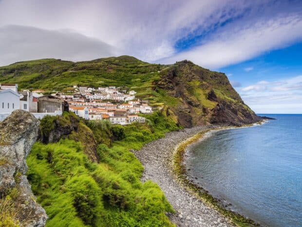 The Azores Wallpapers show a coastal village nestled between green hills and rocky shores, HD Desktop Wallpaper