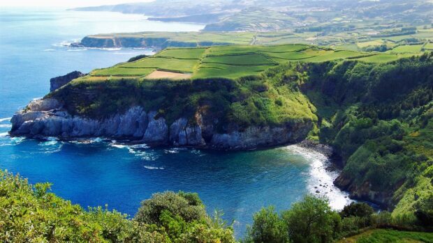 A vibrant coastal landscape in the Azores with cliffs and lush greenery by the ocean, HD Desktop Wallpaper