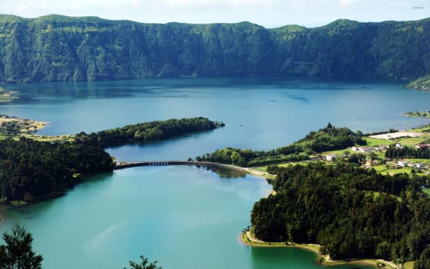 The Azores features a stunning lagoon surrounded by lush green hills and calm waters, 2K Desktop Wallpaper