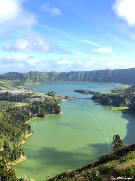 The Azores wallpapers show a breathtaking green lake surrounded by lush hills under a blue sky, HD Desktop Wallpaper