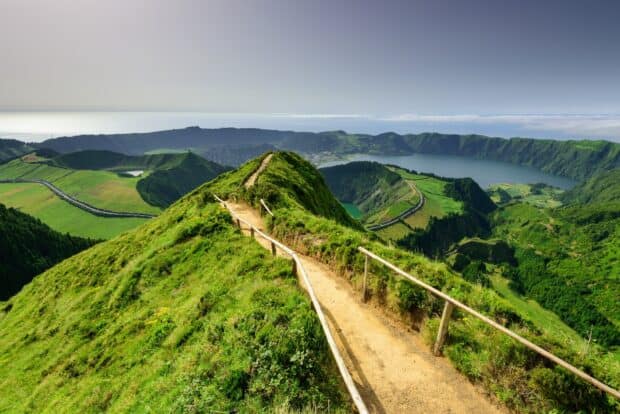 A scenic mountain trail leads through lush greenery above a volcanic lake in The Azores, HD Desktop Wallpaper