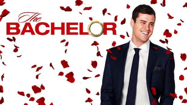 A smiling man in a suit stands among falling red rose petals with The Bachelor TV series logo, HD Desktop Wallpaper