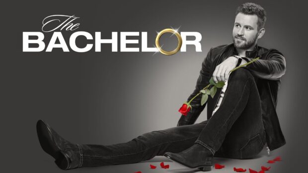A man holding a rose sits surrounded by rose petals in The Bachelor TV series, HD Desktop Wallpaper