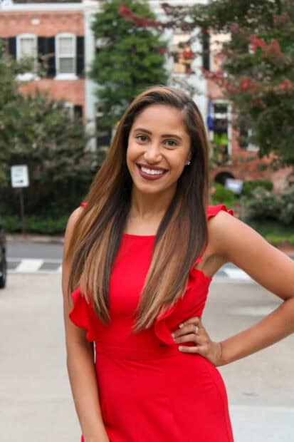 A smiling cast member of The Bachelor TV series poses outdoors in a red dress, HD Mobile Wallpaper