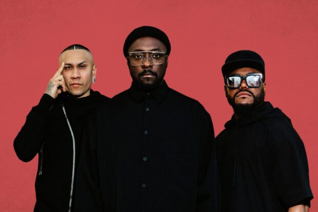 The Black Eyed Peas band members standing against a red background, 2K Desktop Wallpaper