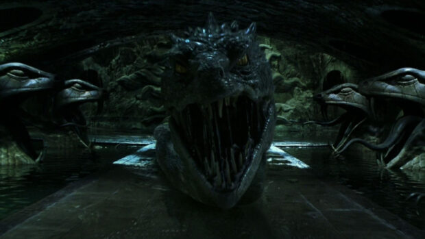 The Chamber Of Secrets dark basilisk statue is shown in a dim underground chamber with serpents on the walls, HD Desktop Wallpaper