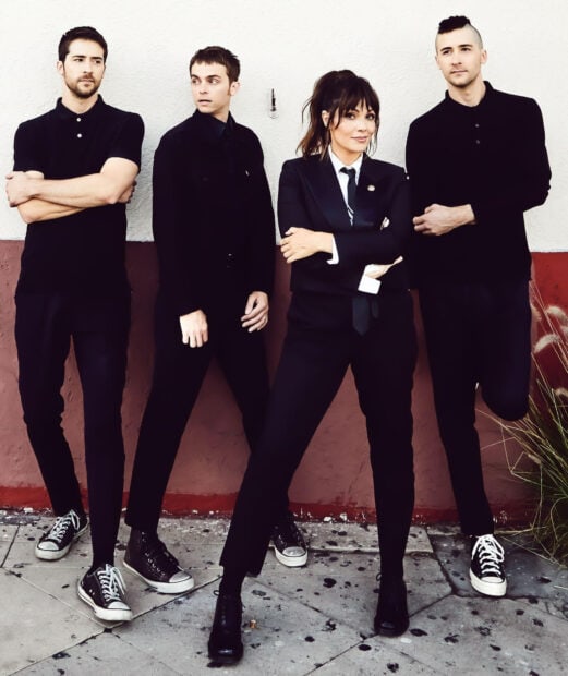The Interrupters stand confidently posing together against a wall, HD Mobile Wallpaper