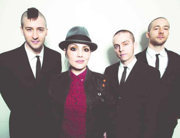 The Interrupters pose together in formal attire against a white background, HD Desktop Wallpaper
