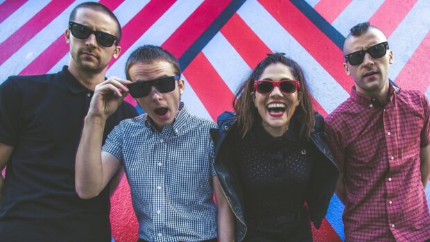 The Interrupters standing together with colorful wall behind them, HD Desktop Wallpaper