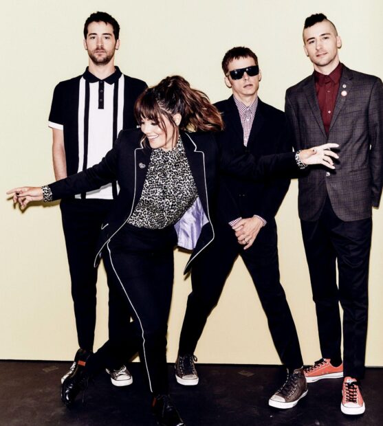 The Interrupters band members posing and smiling in stylish outfits, HD Desktop Wallpaper