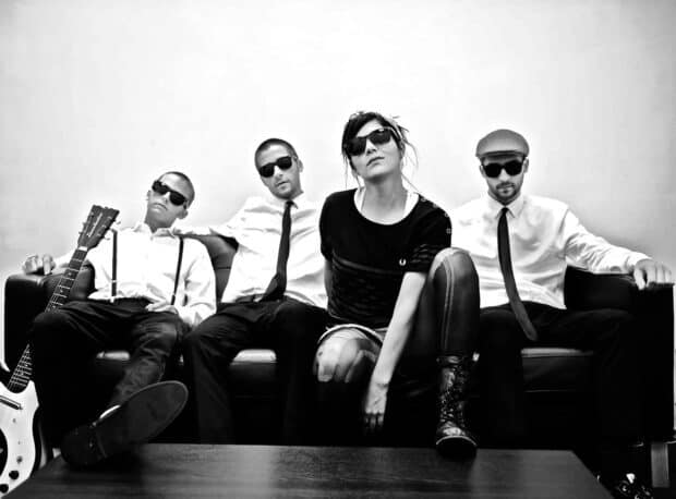 The Interrupters band members wearing sunglasses and casual clothes sitting on a couch, HD Desktop Wallpaper