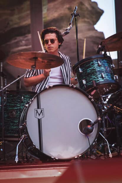 A drummer from The Interrupters is playing the drum set during a concert, HD Phone Wallpaper