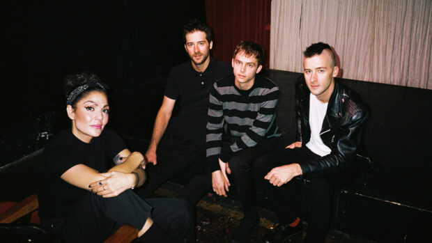 The Interrupters group sitting indoors with casual outfits, HD Desktop Wallpaper
