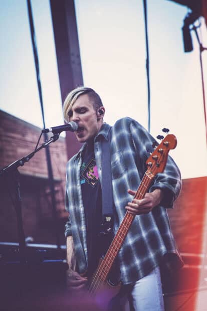 A musician from The Interrupters sings and plays guitar on stage, HD Mobile Wallpaper
