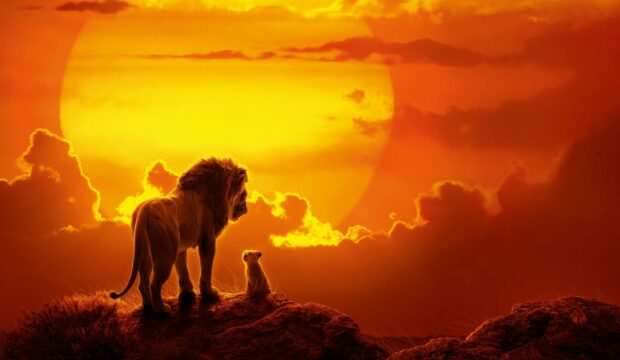 A lion and cub stand on a rock under a large sunset sky in The Lion King, HD Desktop Wallpaper