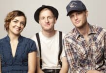 The Lumineers band members are sitting together and smiling at the camera, HD Desktop Wallpaper