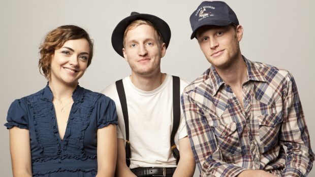 The Lumineers band members are sitting together and smiling at the camera, HD Desktop Wallpaper